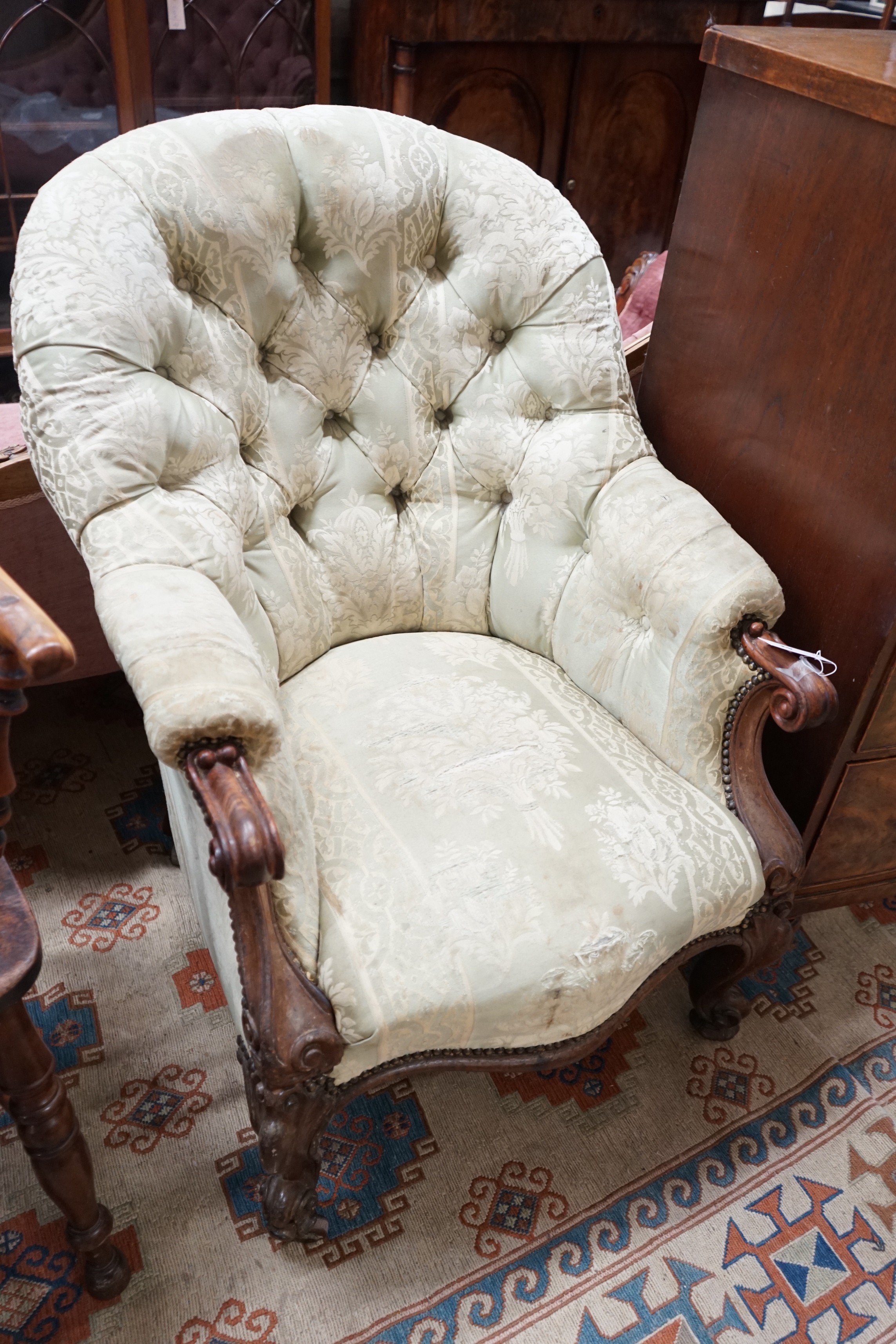 A Victorian rosewood upholstered spoon back armchair, width 66cm, depth 80cm, height 98cm